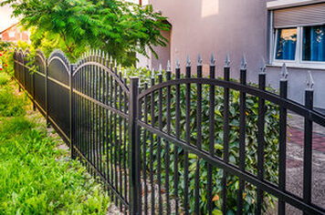 Black metal fencing in front and side yard